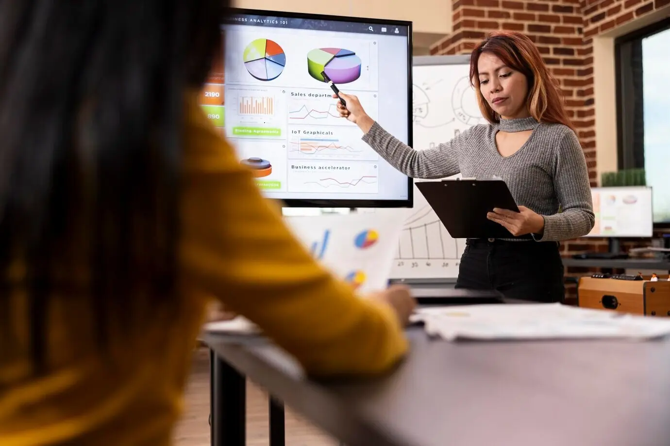 Менеджер-азиатка обучает своего сотрудника.